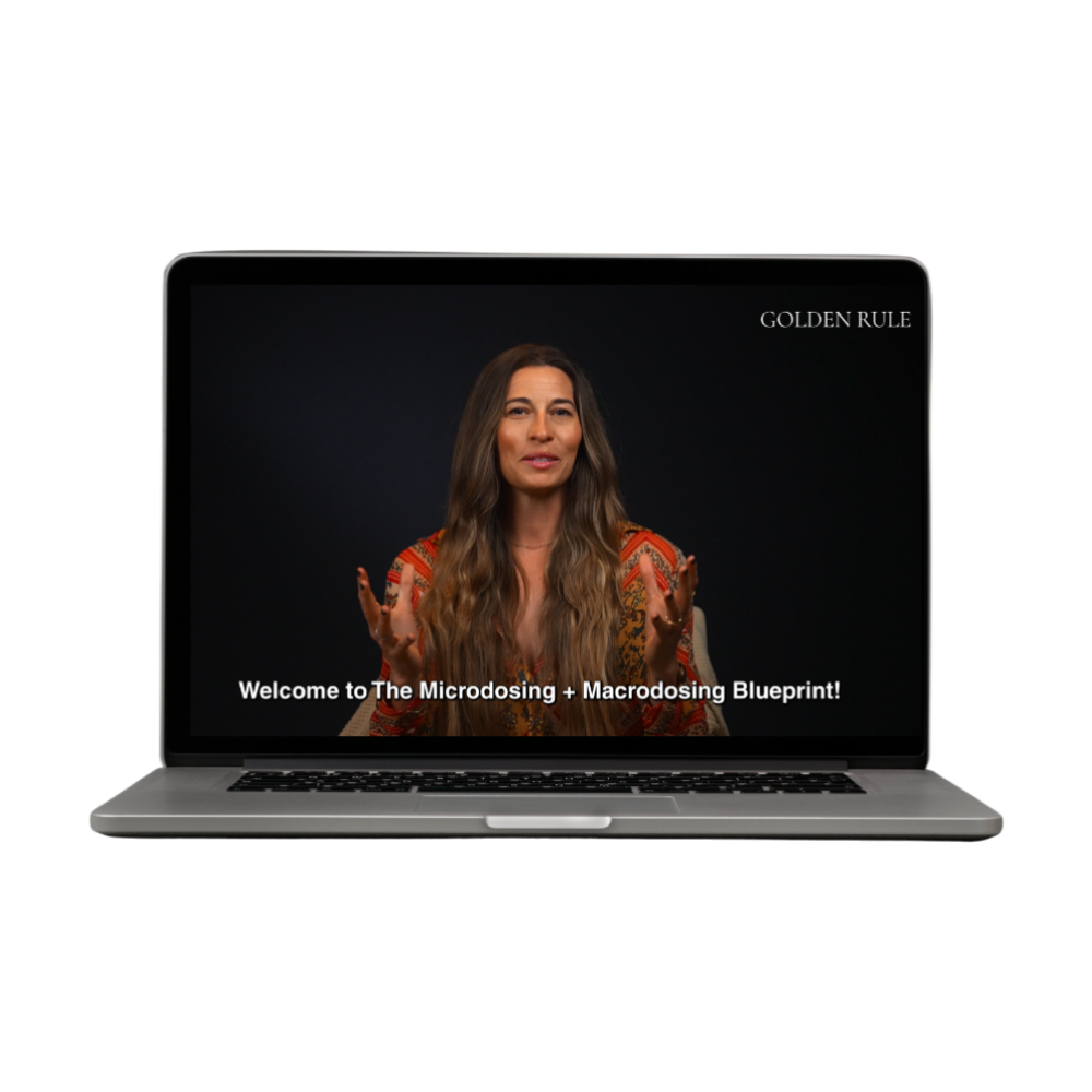 A laptop playing the welcome video of Golden Rule's Microdosing + Macrodosing Blueprint Course