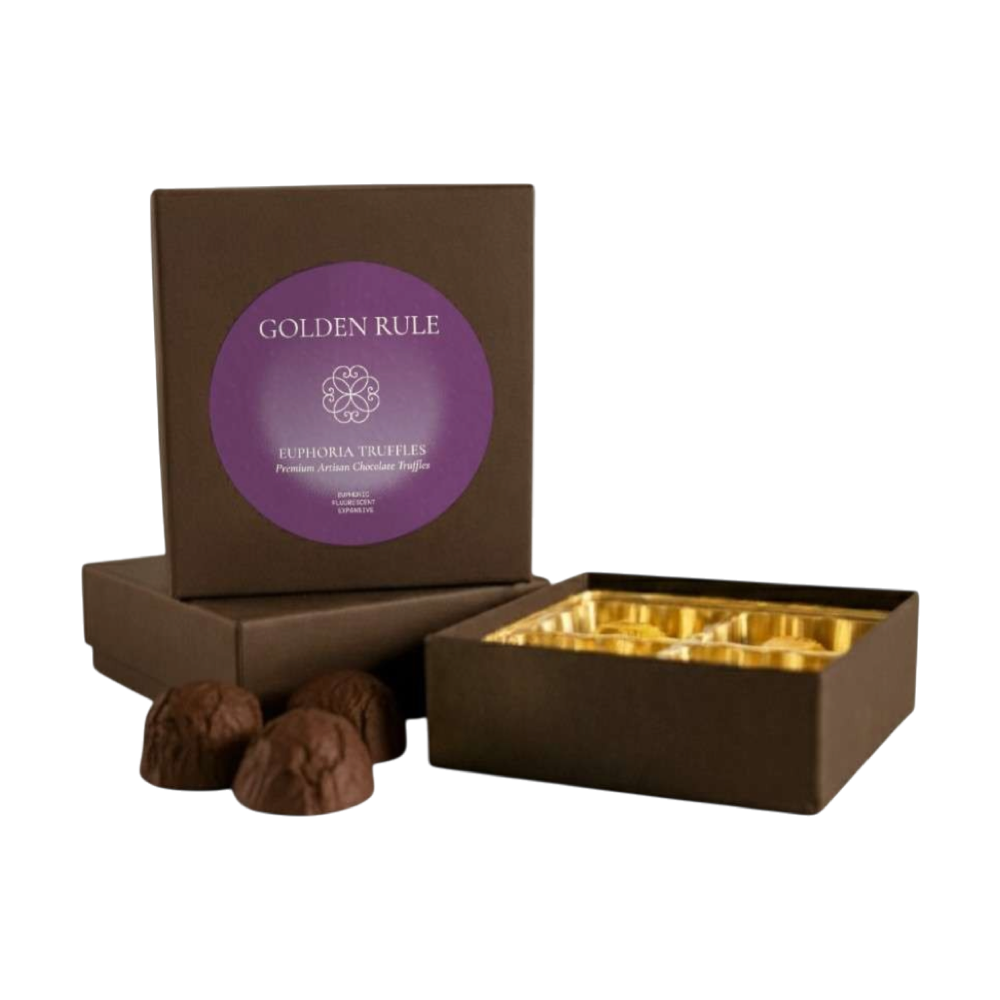 Open box of Golden Rule Euphoria chocolate truffles in a brown gift box with a purple label