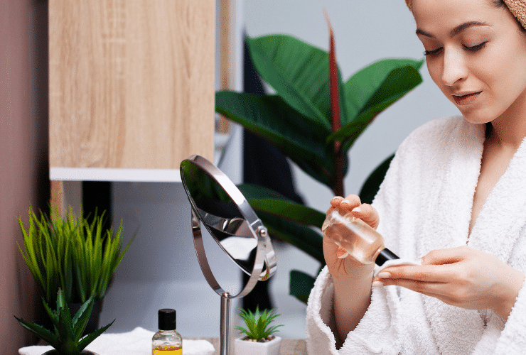 woman applying skin cleanser to hands to remove makeup
