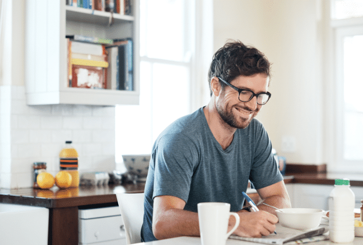 young man with glasses doing a crossword exercise to improve memory
