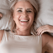 older woman waking up out of bed in the morning