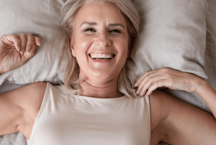 older woman waking up out of bed in the morning